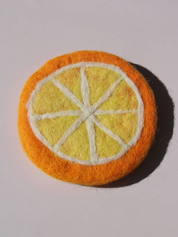 Clementine Handmade Coaster shaped like an orange citrus slice, felted wool coaster with white pith lines