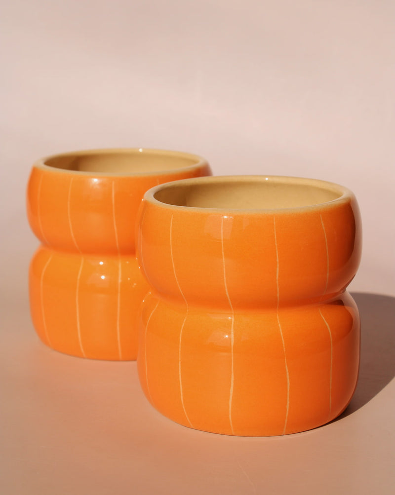 two Belly Tangerine ceramic mugs by Agata Puławska handmade orange coffee cups