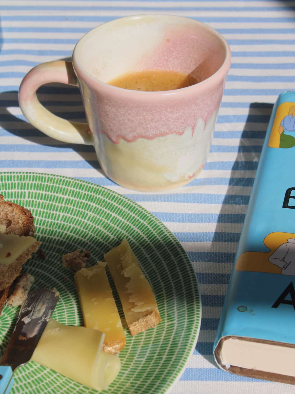 Aurora Sunrise ceramic mug with soft pink and cream glaze, handmade coffee cup styled with breakfast and book