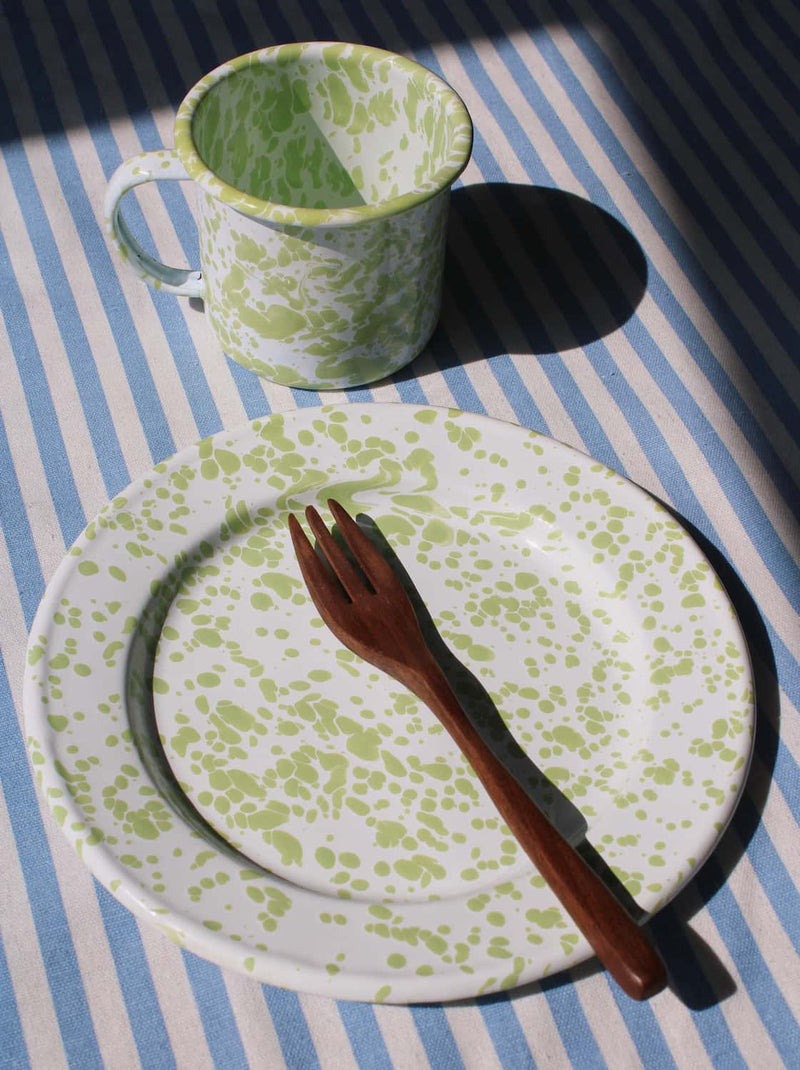 Clover enamel plate and matching enamel tableware in cozy setting