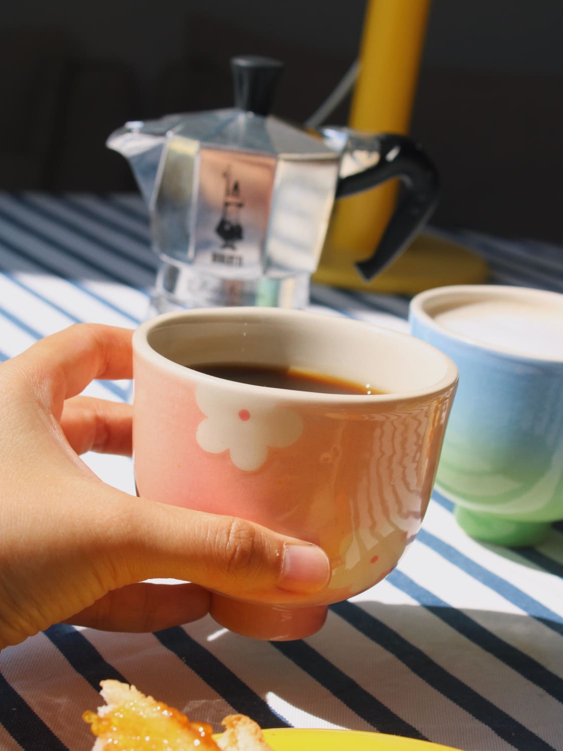 hand holding garden yunomi cup with coffee