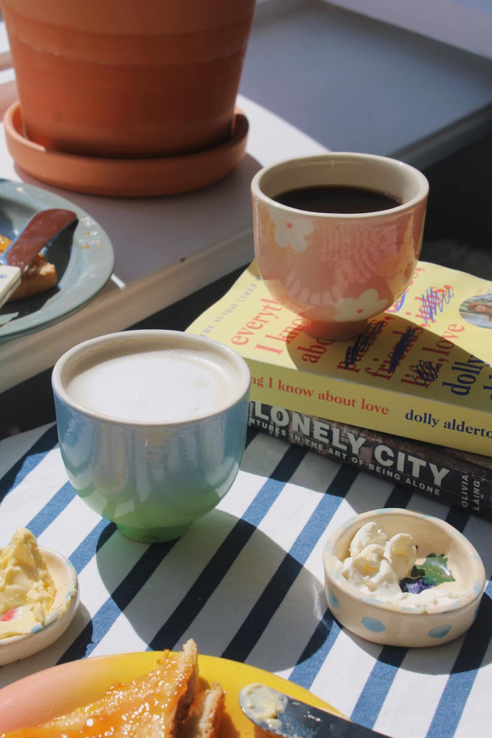 garden yunomi cup and sky yunomi cup on a striped table cloth with breakfast