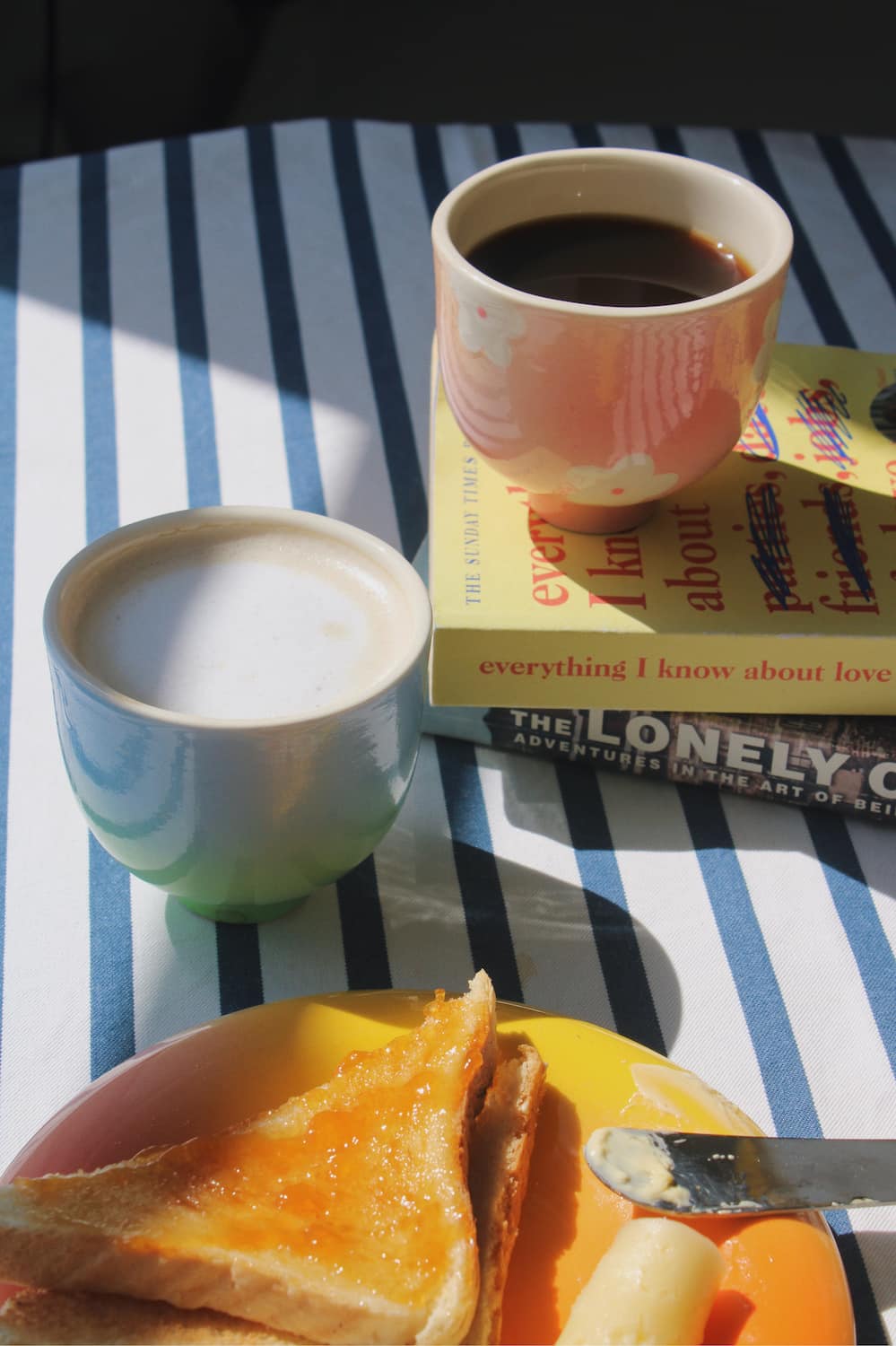 garden yunomi cup and sky yunomi cup on a striped table cloth with breakfast