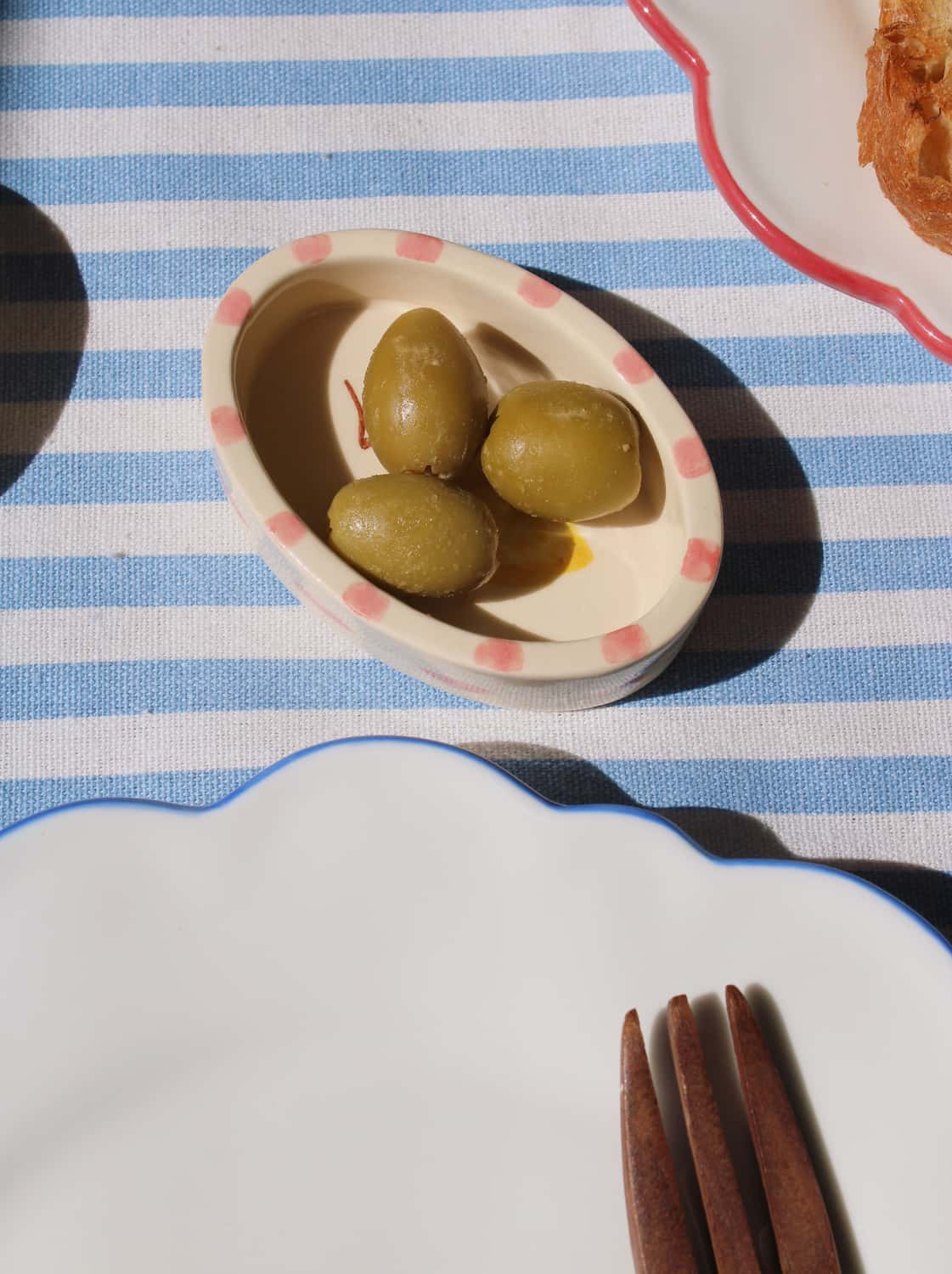 Limonetta ceramic trinket dish with lemon illustration styled on striped tablecloth