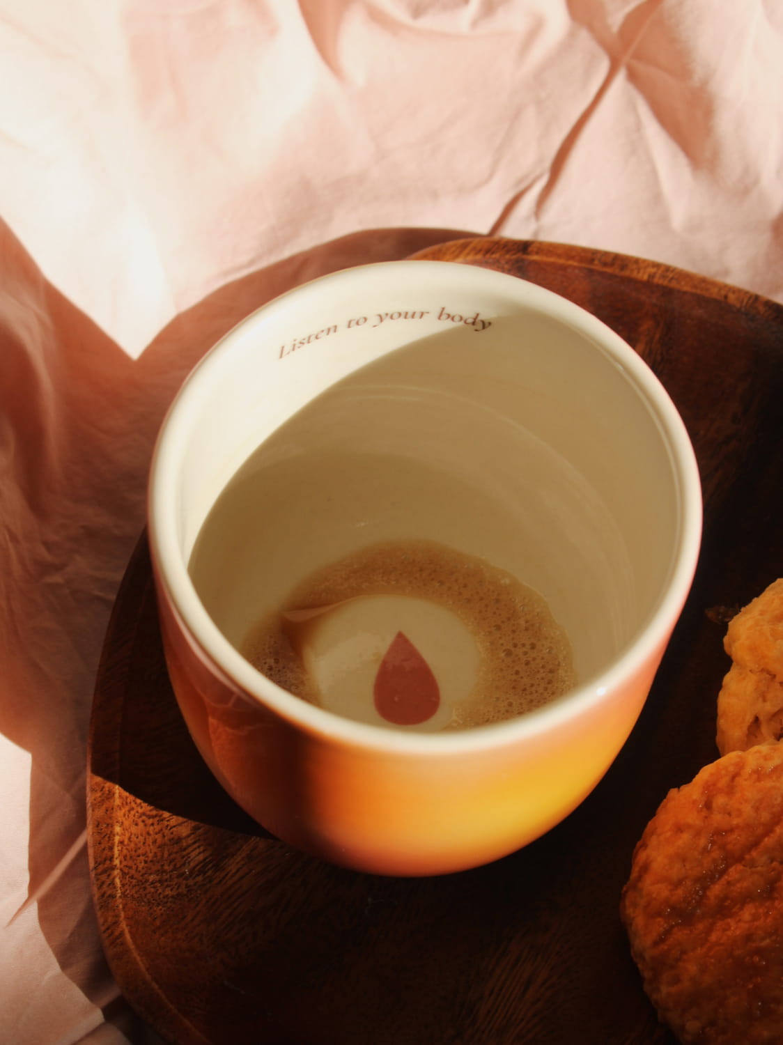 Gradient ceramic mugs in warm orange yellow and pink tones with "Listen to your body" printed inside the rim, handmade in small batches — Listen to Your Body limited edition ceramic mug bladder cancer awareness collection