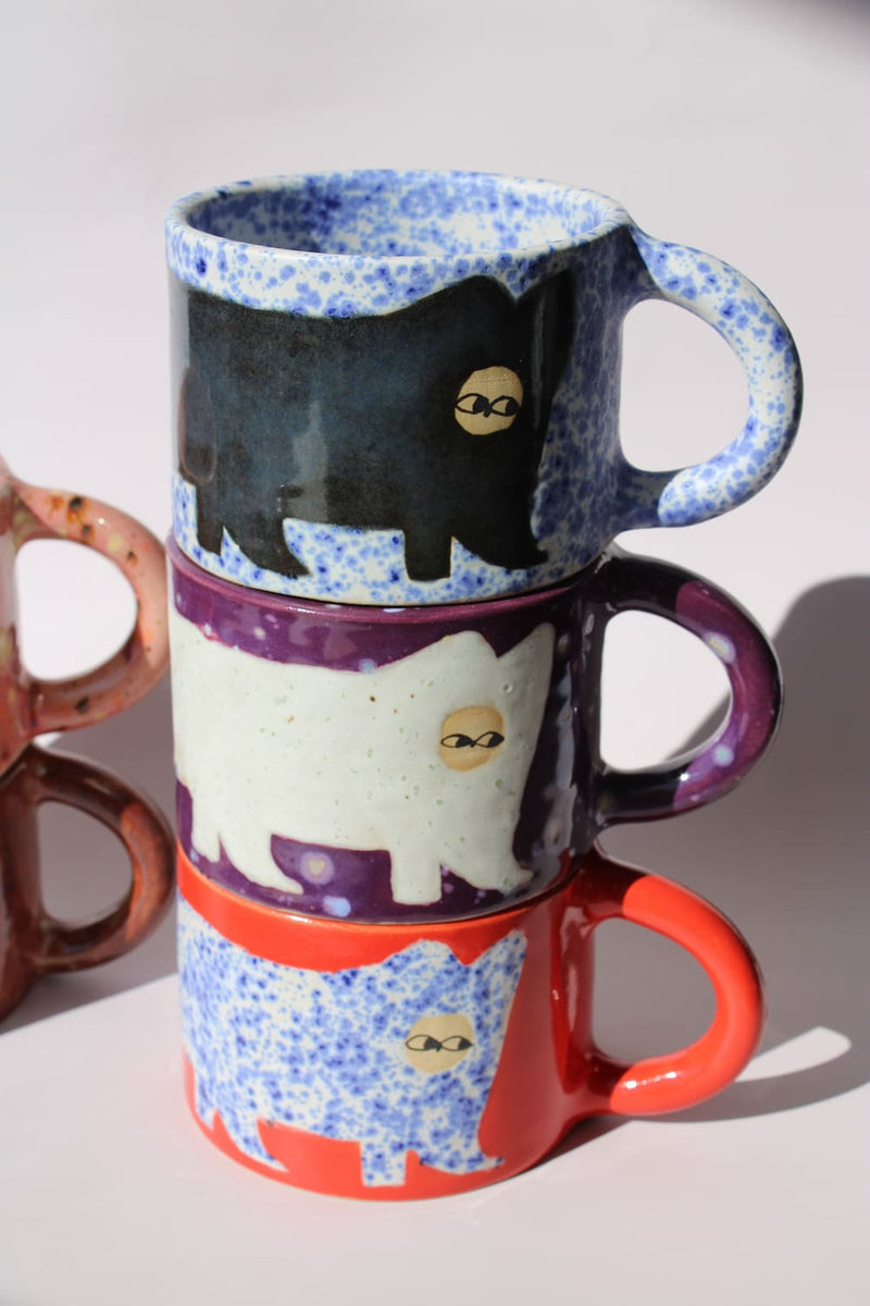 Ceramic Cat Mugs by Marta Shurpakova – six stacked handmade ceramic mugs with hand-painted cat designs 