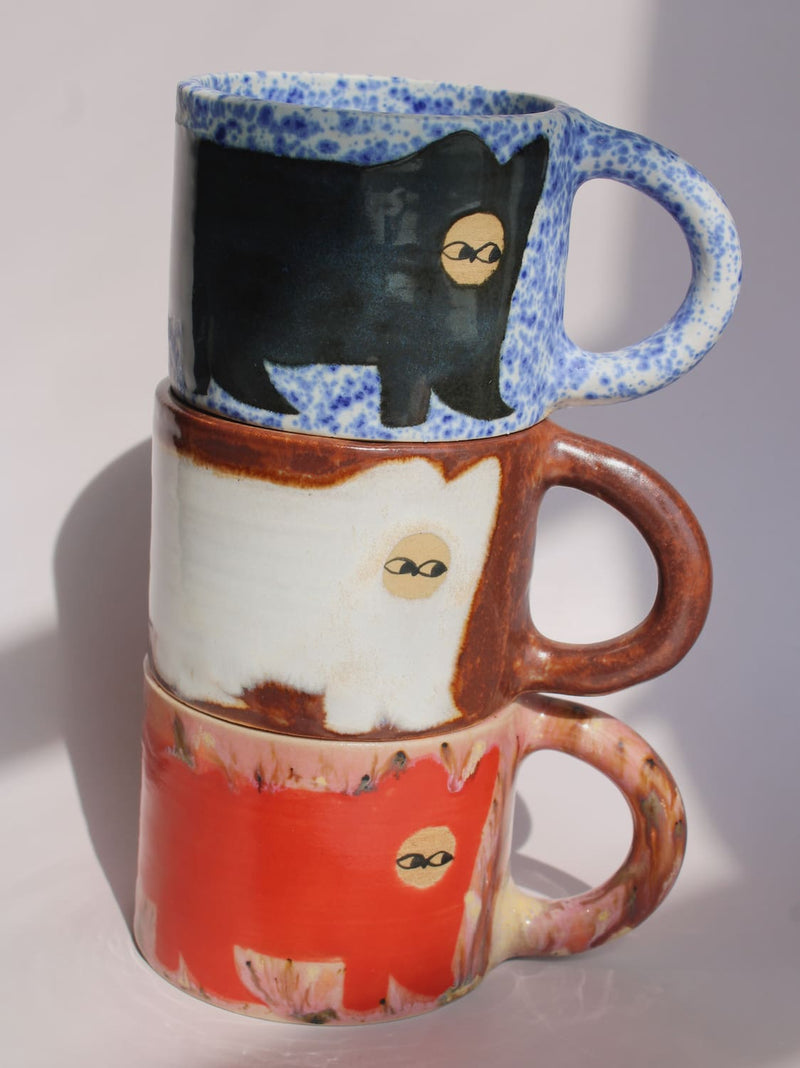 Midnight Cat, Chestnut Cat and Poppy Cat Ceramic Mugs by Marta Shurpakova – three handmade mugs with playful hand-painted cat designs