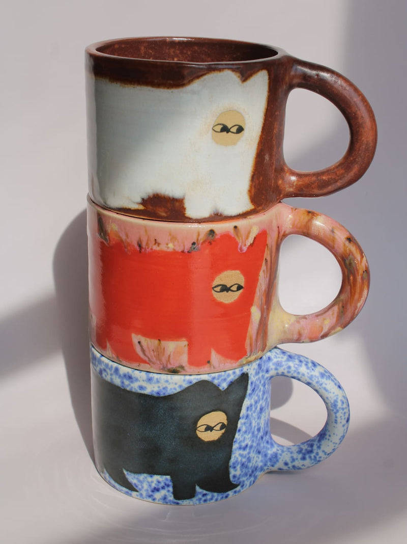 Poppy Ceramic Cat Mugs by Marta Shurpakova – three stacked handmade ceramic mugs with hand-painted cat designs