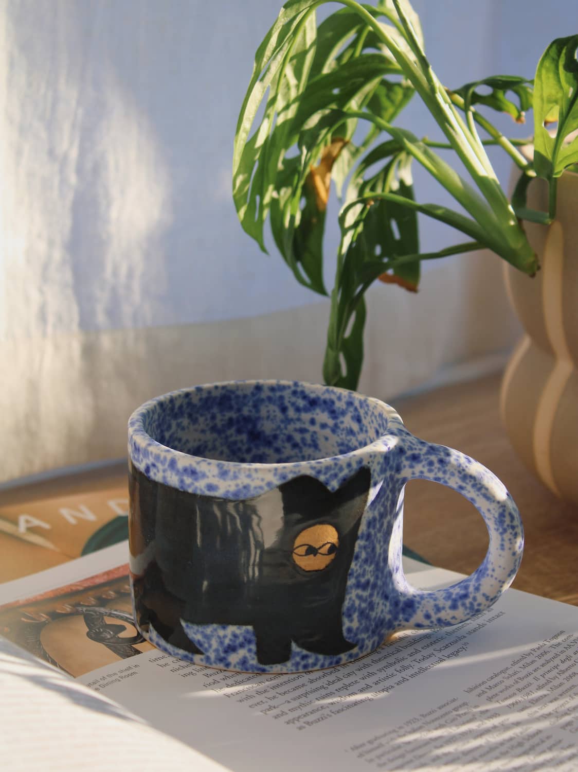Midnight Ceramic Cat Mug by Marta Shurpakova – handmade black and blue ceramic mug with a playful cat design