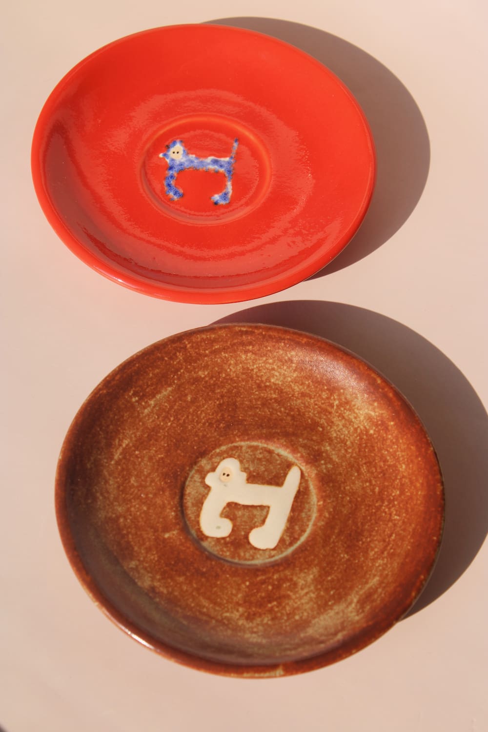 two handmade ceramic monkey plates by Marta Shurpakova artisan dessert plates in different glaze colors