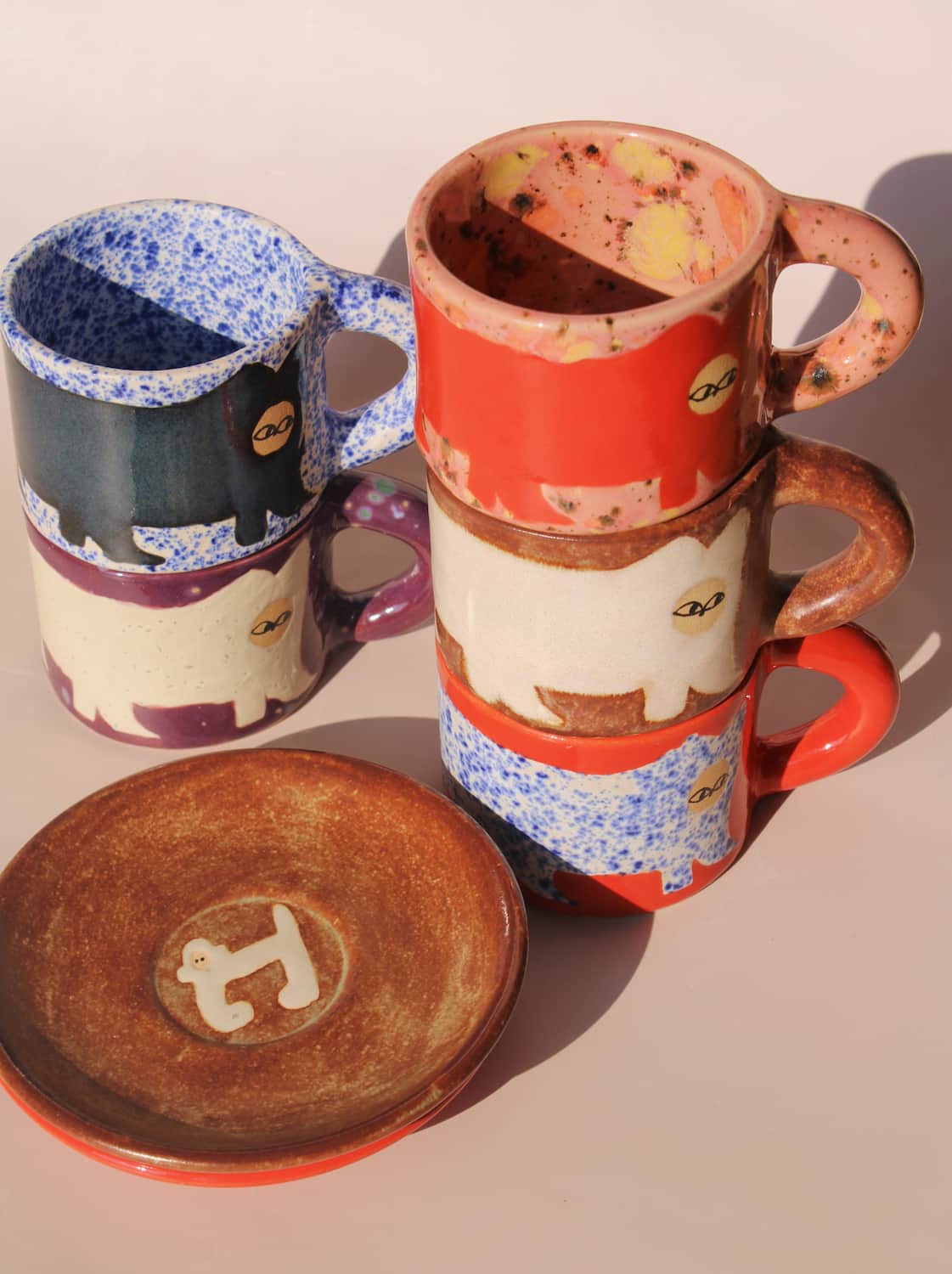 handmade ceramic monkey dessert plate with colorful artisan ceramic mugs by Marta Shurpakova
