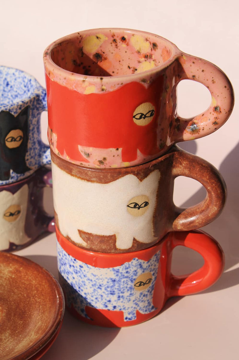 stack of handmade ceramic cat mugs by Marta Shurpakova colorful artisan espresso cups