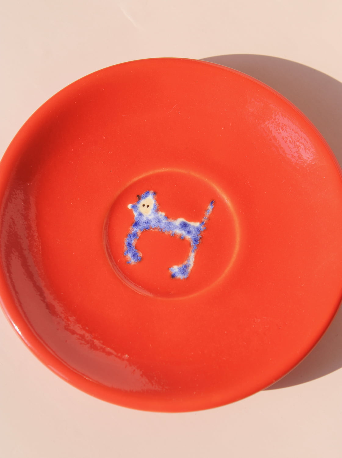 handmade scarlet ceramic monkey dessert plate by Marta Shurpakova artisan snack plate with hand painted monkey illustration
