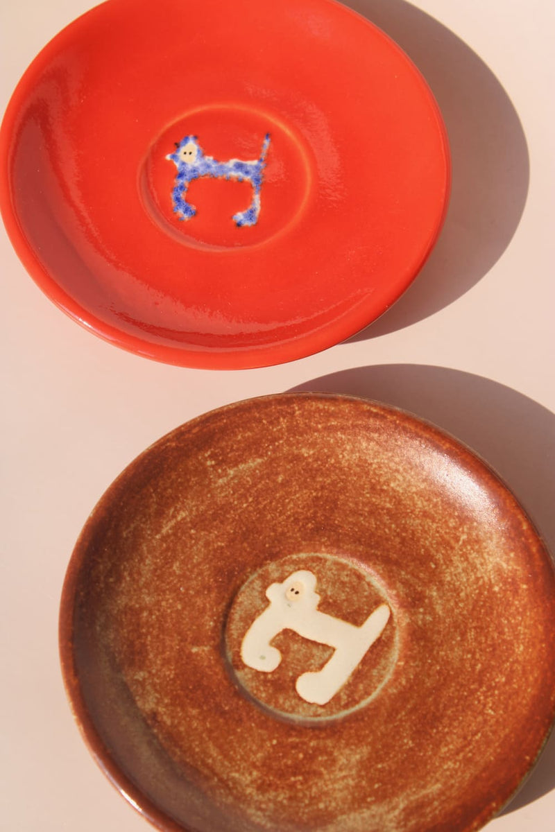 two handmade ceramic monkey plates by Marta Shurpakova artisan dessert plates in different glaze colors