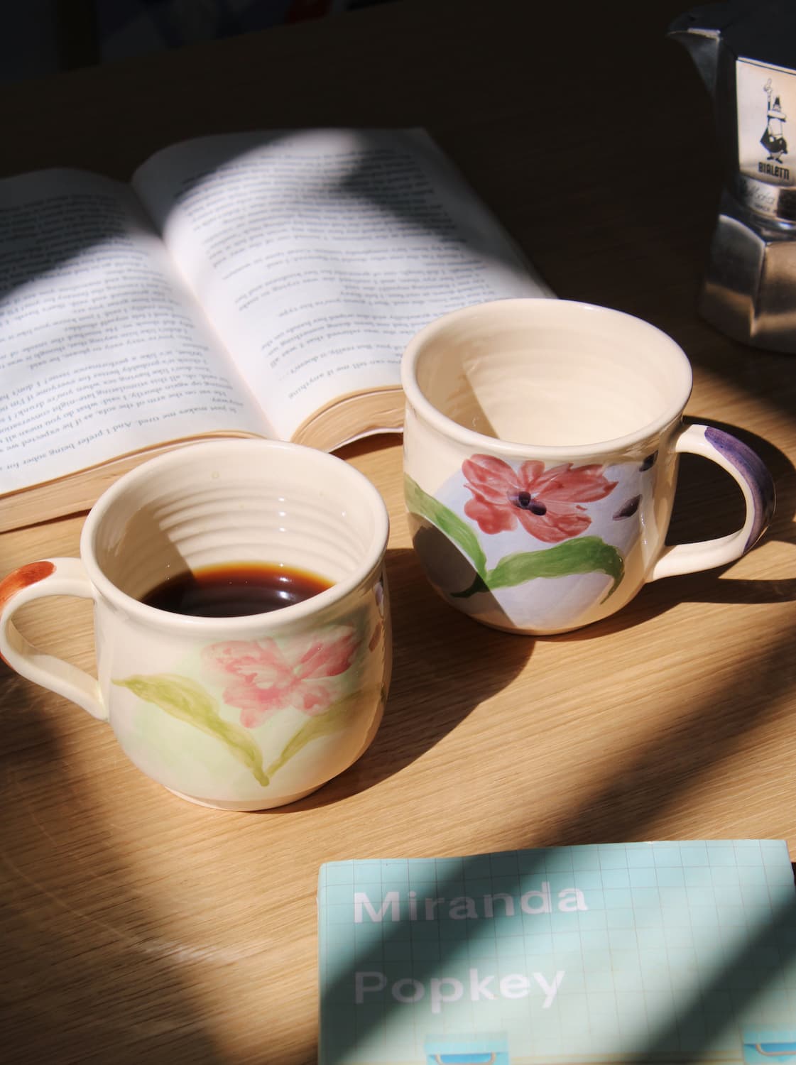 Petalia ceramic mug paired with Camellia mug on table in cozy morning setting