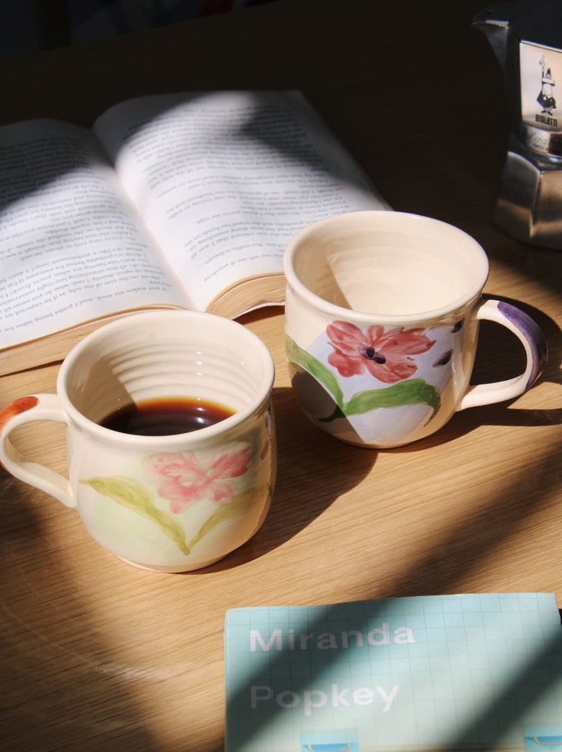 Petalia ceramic mug paired with Camellia mug on table in cozy morning setting