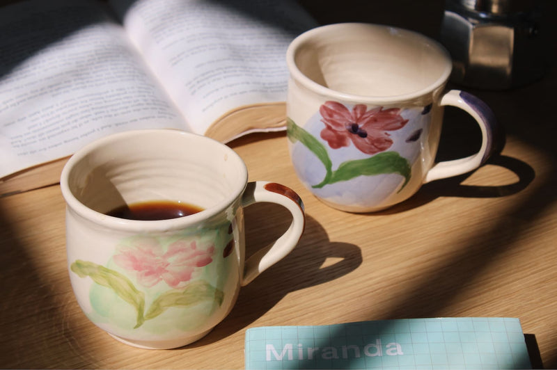 Petalia ceramic mug paired with Camellia mug on table in cozy morning setting