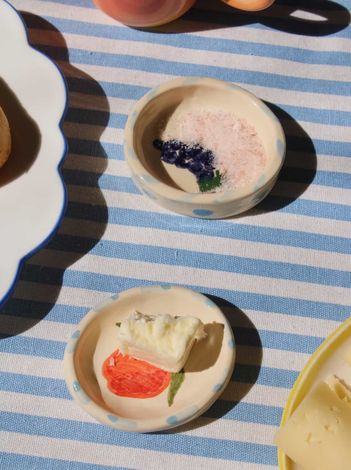Handmade Pomina trinket dish and Vinea trinket dish with colorful fruit motif styled with breakfast setting