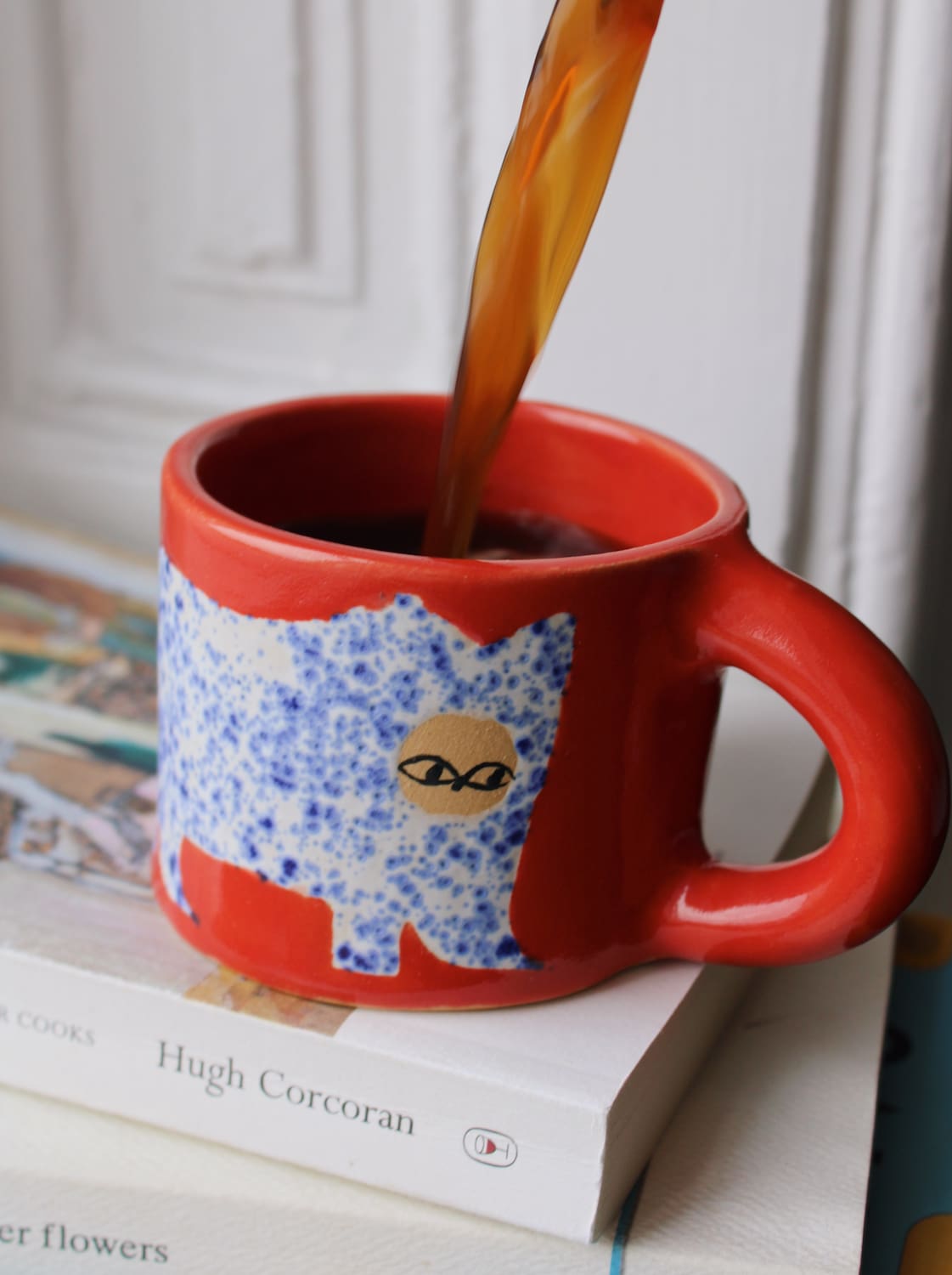Scarlet ceramic cat mug with hand-painted blue cat illustration and red handle