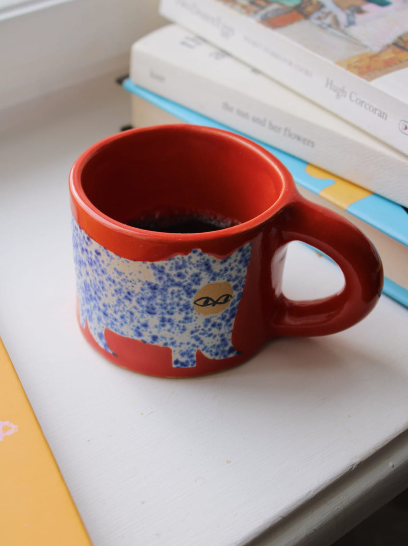 Scarlet ceramic cat mug with hand-painted blue cat illustration and red handle