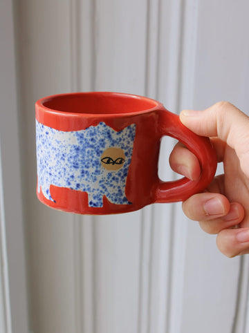 Scarlet ceramic cat mug with hand-painted blue cat illustration and red handle