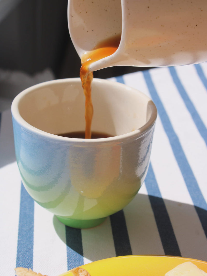 coffee being poured into the sky yunomi cup with blue and green glaze 