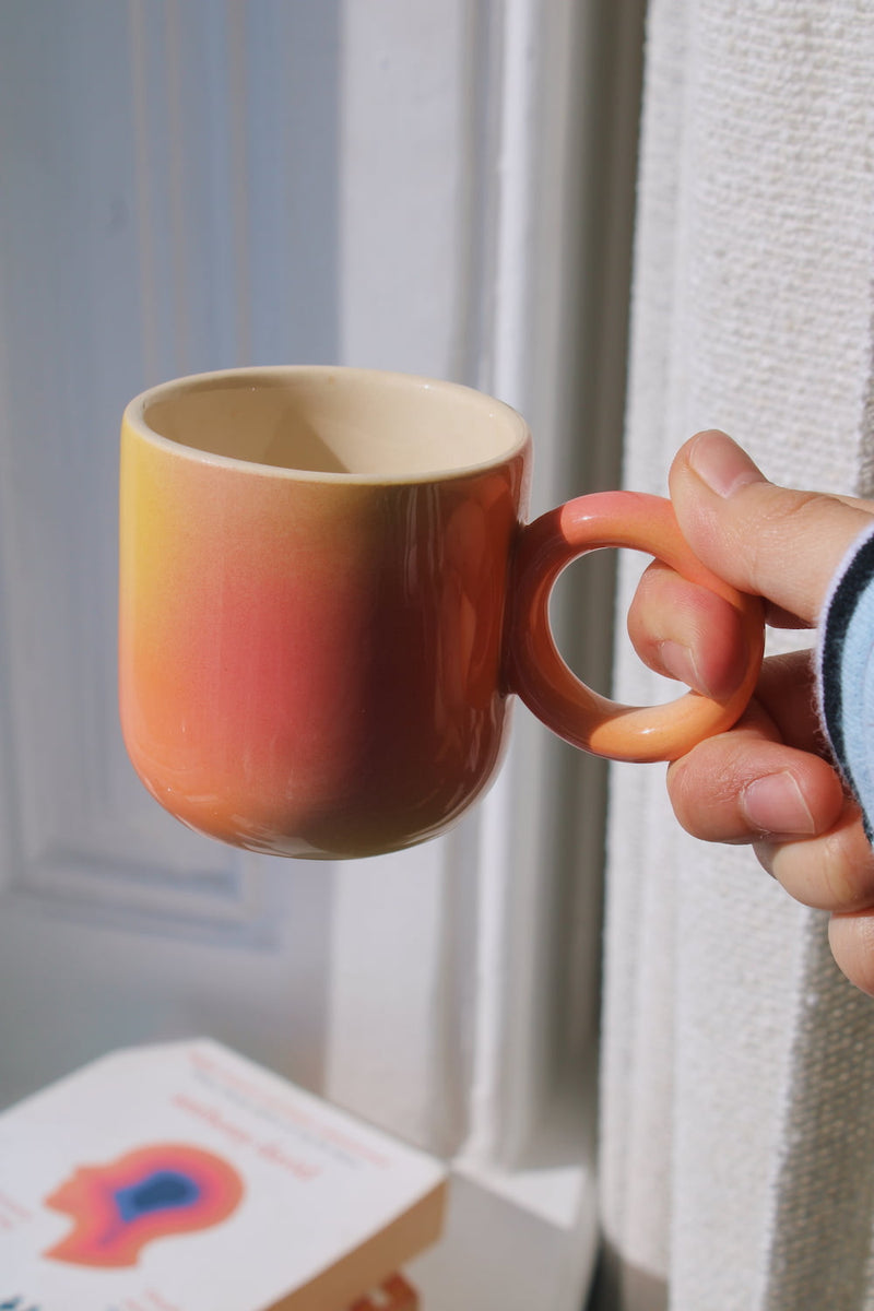 Solstice espresso cup in soft sunlight, handmade ceramic espresso cup with warm ombre finish