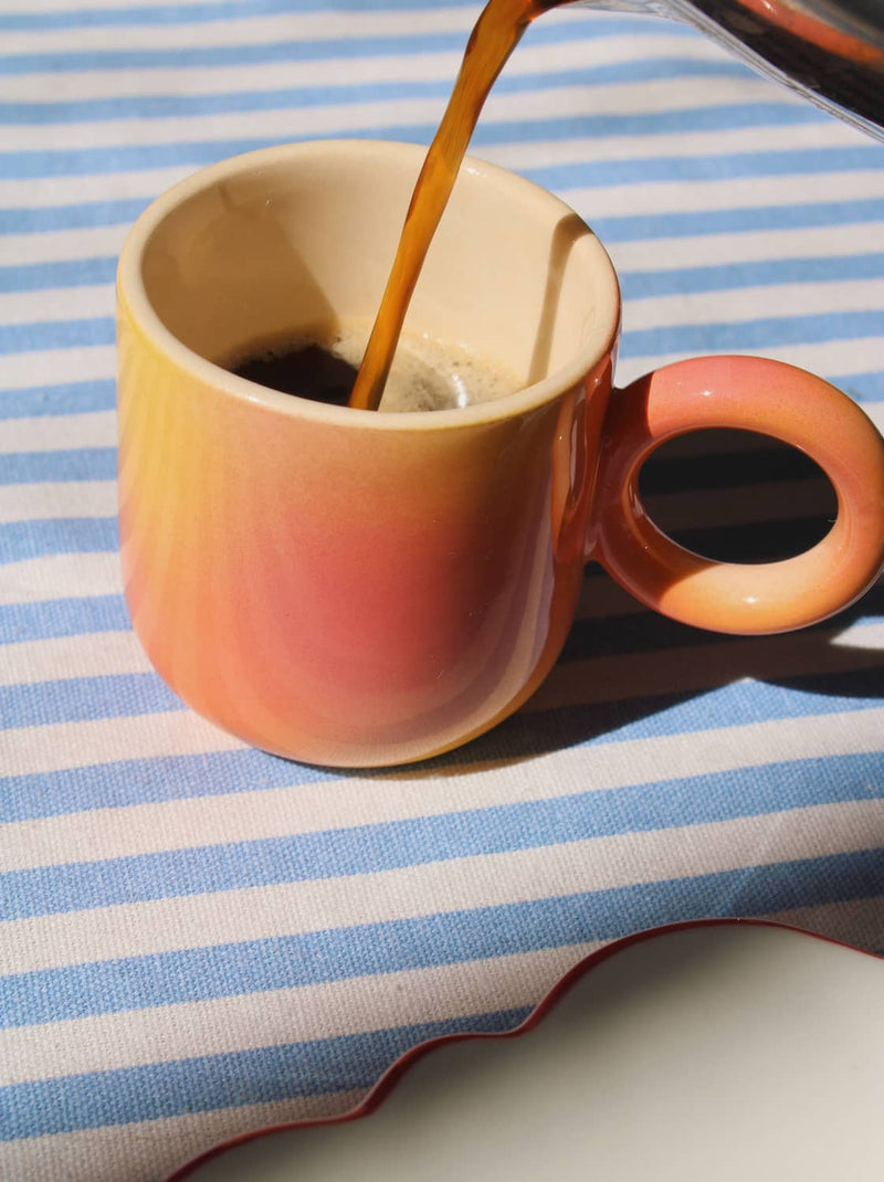 Solstice espresso cup in soft sunlight, handmade ceramic espresso cup with warm ombre finish